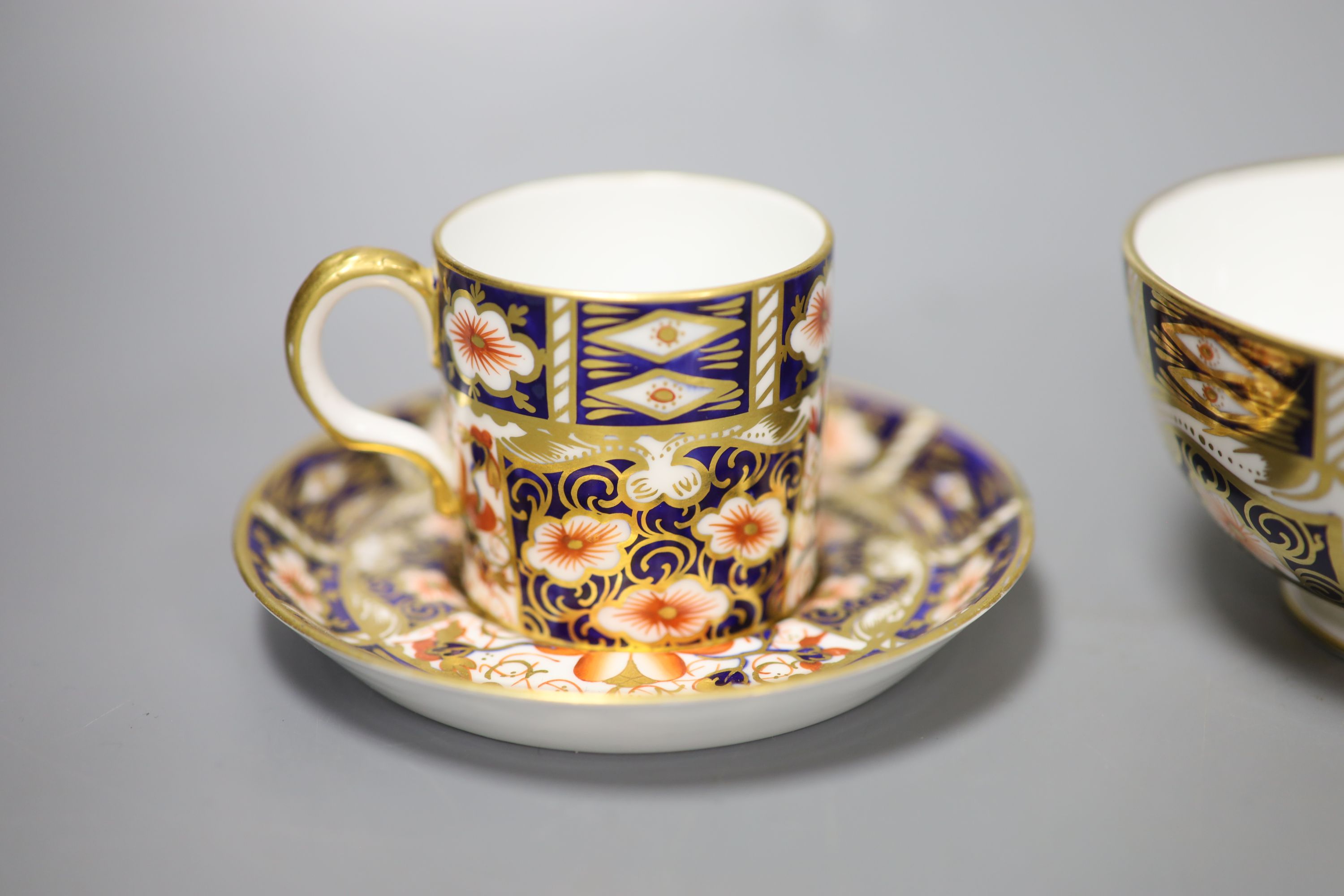 A pair of Royal Crown Derby coffee cups, imari pattern 2451, a coffee can and saucer and a sugar bowl